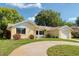 Charming one-story home with a brick facade, well-maintained lawn, and a curved driveway at 8505 Lincolnshire Dr, Hudson, FL 34667