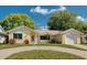 Charming one-story home with a brick facade, well-maintained lawn, and a curved driveway at 8505 Lincolnshire Dr, Hudson, FL 34667