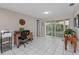 Bright home office with neutral walls, tile floors, and sliding glass doors to the backyard at 8505 Lincolnshire Dr, Hudson, FL 34667
