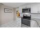 Updated kitchen featuring stainless steel appliances and white cabinets at 8505 Lincolnshire Dr, Hudson, FL 34667