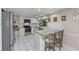 Bright kitchen with white cabinets, stainless appliances, and granite countertops on the breakfast bar at 8505 Lincolnshire Dr, Hudson, FL 34667