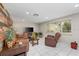 Cozy living room features a reclaimed wood accent wall and lots of natural light at 8505 Lincolnshire Dr, Hudson, FL 34667