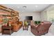 Comfortable living room with a rustic wood accent wall and tile floors at 8505 Lincolnshire Dr, Hudson, FL 34667