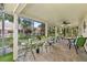 Enclosed lanai featuring ample seating arrangements, creating a cozy and inviting outdoor space at 8505 Lincolnshire Dr, Hudson, FL 34667