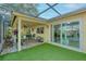 Covered patio features patterned tile, seating, and a view of the lawn and sliding glass doors at 8505 Lincolnshire Dr, Hudson, FL 34667