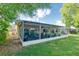 Back of house featuring a spacious screened-in lanai perfect for outdoor relaxation and entertaining at 8505 Lincolnshire Dr, Hudson, FL 34667