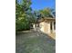 View of the side yard with trees and partial fencing at 8711 Cutlass Dr, Hudson, FL 34667