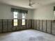 Bedroom with dual windows, fan, and incomplete walls allows creativity in finishing at 8711 Cutlass Dr, Hudson, FL 34667