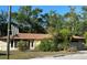 Cozy single-story home surrounded by mature trees and a fenced yard, brimming with potential at 8711 Cutlass Dr, Hudson, FL 34667