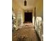 Inviting front porch features mosaic tile flooring, arched entryway, and lantern-style lighting at 8711 Cutlass Dr, Hudson, FL 34667