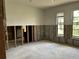 Living room featuring large windows and original concrete flooring, awaiting personalization at 8711 Cutlass Dr, Hudson, FL 34667