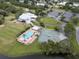 Aerial view of clubhouse featuring community pool, tennis courts, and golf course at 9147 Rhett Ln, Weeki Wachee, FL 34613