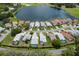 Aerial view of a community with single-Gathering homes, lush landscaping and a serene lake view at 9147 Rhett Ln, Weeki Wachee, FL 34613