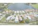 Aerial view of a single-Gathering home in a gated community with lush landscaping and lake views at 9147 Rhett Ln, Weeki Wachee, FL 34613