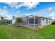Scenic backyard with a screened patio and well-maintained lawn, ideal for outdoor living and entertaining at 9147 Rhett Ln, Weeki Wachee, FL 34613