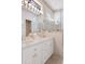 Bathroom featuring a double vanity, large mirrors, and a frameless glass shower with tile surround at 9147 Rhett Ln, Weeki Wachee, FL 34613