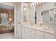 Bathroom featuring a double vanity, large mirrors, and access to en-suite bedroom at 9147 Rhett Ln, Weeki Wachee, FL 34613