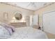 Cozy bedroom featuring decorative wallpaper, dresser with mirror and comfortable furniture at 9147 Rhett Ln, Weeki Wachee, FL 34613