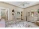 Bedroom with floral bedding, light walls, and en-suite bath with a spacious double vanity at 9147 Rhett Ln, Weeki Wachee, FL 34613