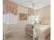 Charming bedroom featuring decorative wallpaper, vintage-style furnishings and a cozy window seat at 9147 Rhett Ln, Weeki Wachee, FL 34613