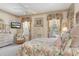 Charming bedroom with floral bedding, light walls, and lots of natural light from the windows at 9147 Rhett Ln, Weeki Wachee, FL 34613