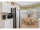 Bright breakfast nook with tile floors, offering great natural lighting, wicker chairs, and backyard views at 9147 Rhett Ln, Weeki Wachee, FL 34613