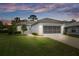 Charming single-story home with well-manicured lawn, attractive landscaping, and a neutral color palette at 9147 Rhett Ln, Weeki Wachee, FL 34613