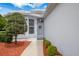 Charming front entrance with beautiful shrubbery and colorful landscaping at 9147 Rhett Ln, Weeki Wachee, FL 34613