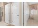 Bright hallway with white doors and a decorative chair creating an inviting and charming space at 9147 Rhett Ln, Weeki Wachee, FL 34613