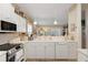 Kitchen with white countertops and adjacent breakfast area with plentiful natural light and view to living area at 9147 Rhett Ln, Weeki Wachee, FL 34613