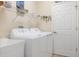 Efficient laundry room with modern appliances, ample storage shelving and functional design at 9147 Rhett Ln, Weeki Wachee, FL 34613