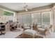 Comfortable living area with wicker chairs, a desk, and large windows offering backyard views at 9147 Rhett Ln, Weeki Wachee, FL 34613