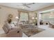 Cozy living room featuring a neutral color palette, ceiling fan and nice furniture at 9147 Rhett Ln, Weeki Wachee, FL 34613
