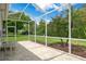 Relaxing screened patio with outdoor seating, offering a serene view of the landscaped backyard at 9147 Rhett Ln, Weeki Wachee, FL 34613