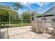 Outdoor screen patio with brick pavers, views of landscaped backyard, and a dining set at 9147 Rhett Ln, Weeki Wachee, FL 34613