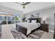 Nautical-themed main bedroom with balcony access, a ceiling fan, and a decorative area rug at 920 N Osceola Ave # 203, Clearwater, FL 33755