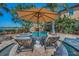 Backyard oasis with a swimming pool, hot tub, fire pit, lounge chairs, and tropical landscaping at 10019 Milano Dr, Trinity, FL 34655