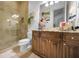 Updated bathroom featuring a glass shower, granite vanity, and modern fixtures at 10019 Milano Dr, Trinity, FL 34655