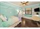 Bright bedroom features a canopy bed, built-in shelving, window seat, and stylish decor at 10019 Milano Dr, Trinity, FL 34655