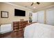 Comfortable bedroom with dark wood floors, a large bed and a TV at 10019 Milano Dr, Trinity, FL 34655