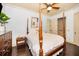 Cozy bedroom with a four poster bed, dark hardwood flooring, and neutral decor at 10019 Milano Dr, Trinity, FL 34655