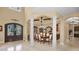 Elegant dining room featuring white columns, large dining table, and arched entry to other rooms at 10019 Milano Dr, Trinity, FL 34655