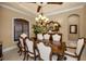 Close up of formal dining table and chairs, chandelier, and buffet with mirror at 10019 Milano Dr, Trinity, FL 34655