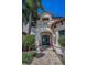 Inviting entryway with meticulously manicured landscaping and classic architectural details at 10019 Milano Dr, Trinity, FL 34655