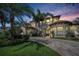 Elegant home with lush landscaping and a brick driveway creating a welcoming entrance at 10019 Milano Dr, Trinity, FL 34655