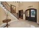 Grand foyer featuring a wrought iron staircase, soaring ceilings, and elegant decor at 10019 Milano Dr, Trinity, FL 34655