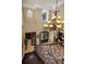 A second floor view of the foyer showing chandelier, staircase, and entry to other rooms at 10019 Milano Dr, Trinity, FL 34655