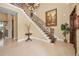 Spacious foyer with elegant staircase, high ceilings, and tasteful decorative accents at 10019 Milano Dr, Trinity, FL 34655