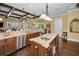 Spacious kitchen with granite countertops, island, stainless steel appliances, and dark wood cabinetry at 10019 Milano Dr, Trinity, FL 34655