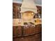 Gourmet kitchen with custom cabinetry, granite countertops and modern gas cooktop at 10019 Milano Dr, Trinity, FL 34655
